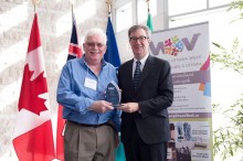 Rudi Aksim receives his Welcoming Ottawa Ambassador award from Mayor Jim Watson